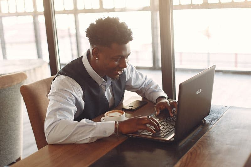 man on laptop planning virtual event