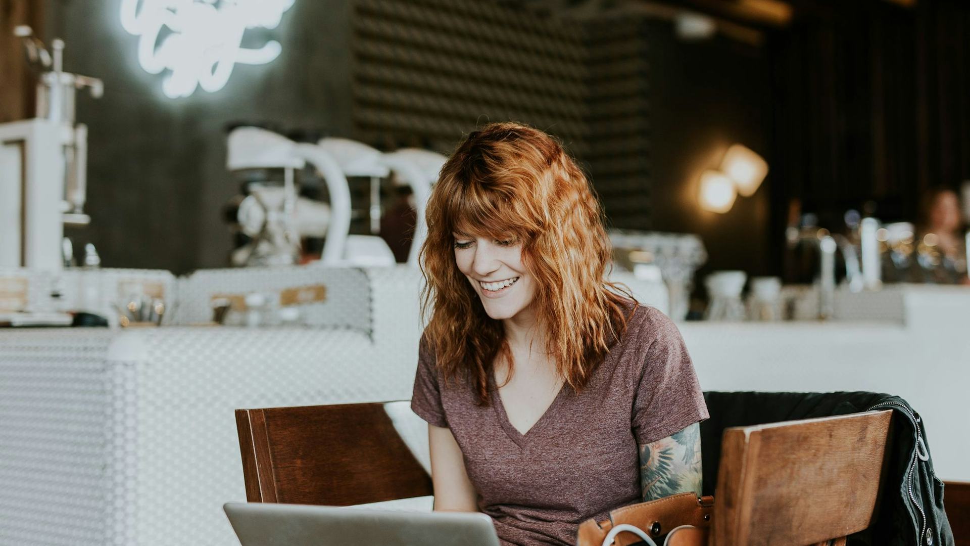woman looking at laptop and smiling