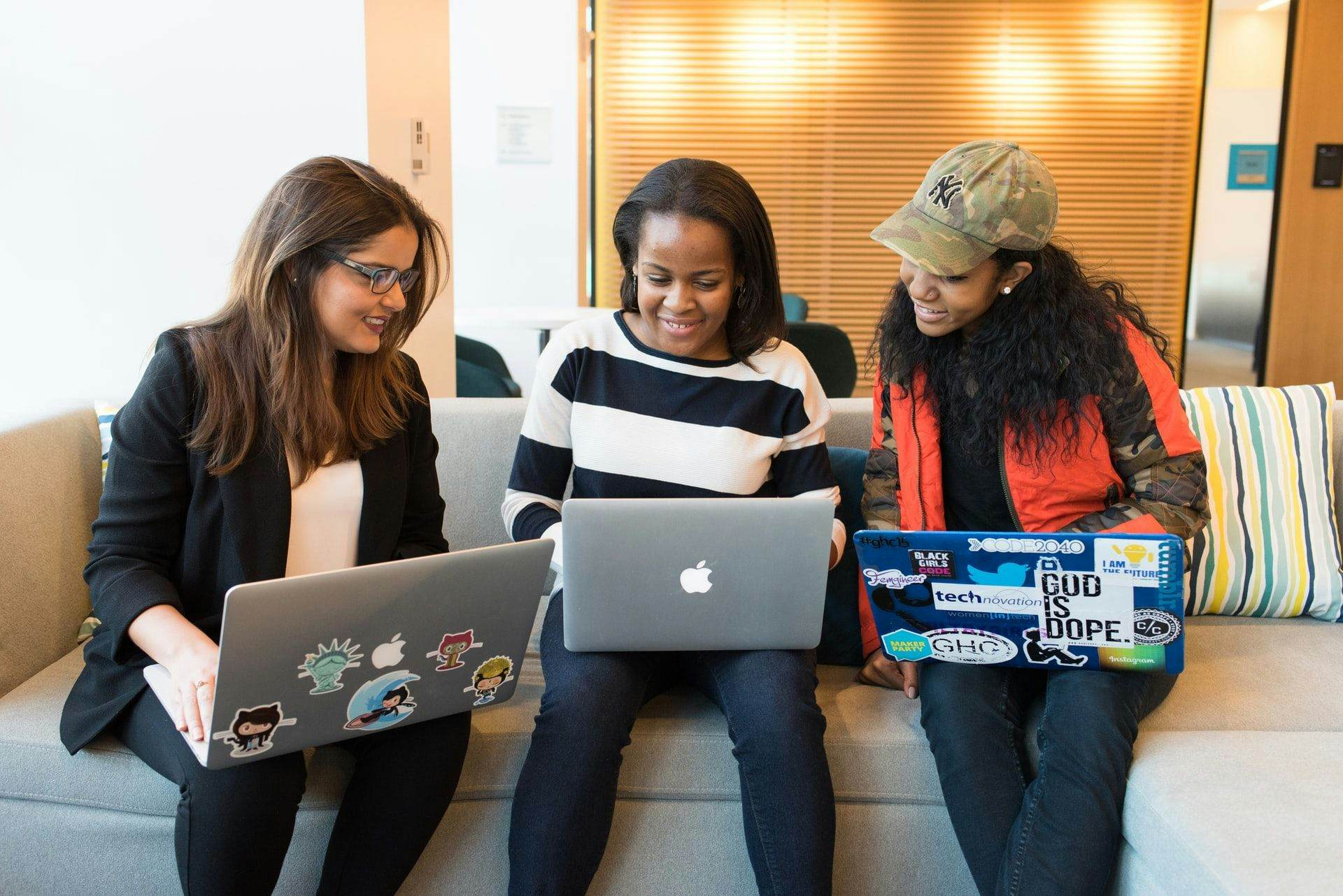 3 colleagues on laptops