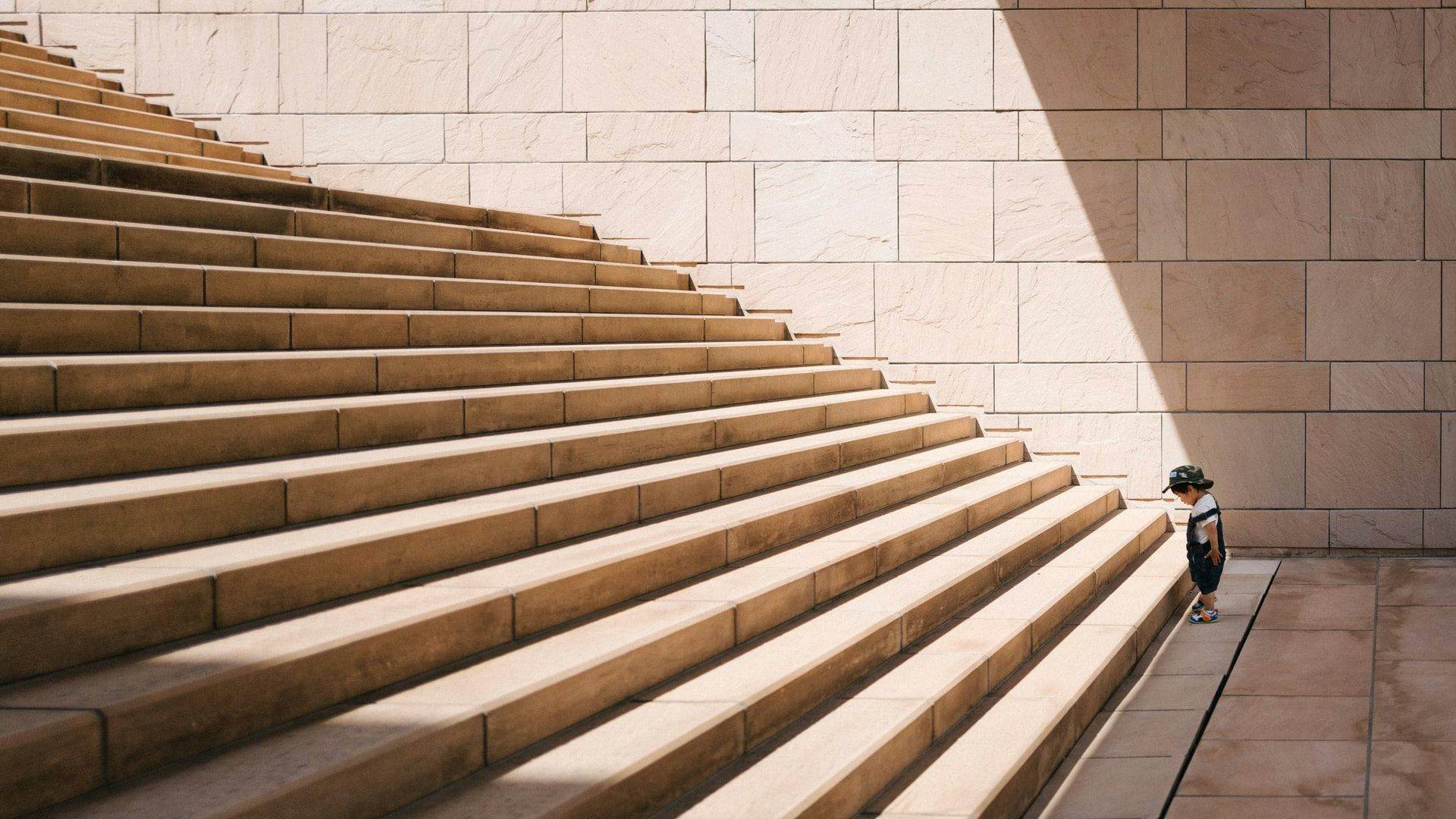 child at bottom of stairs