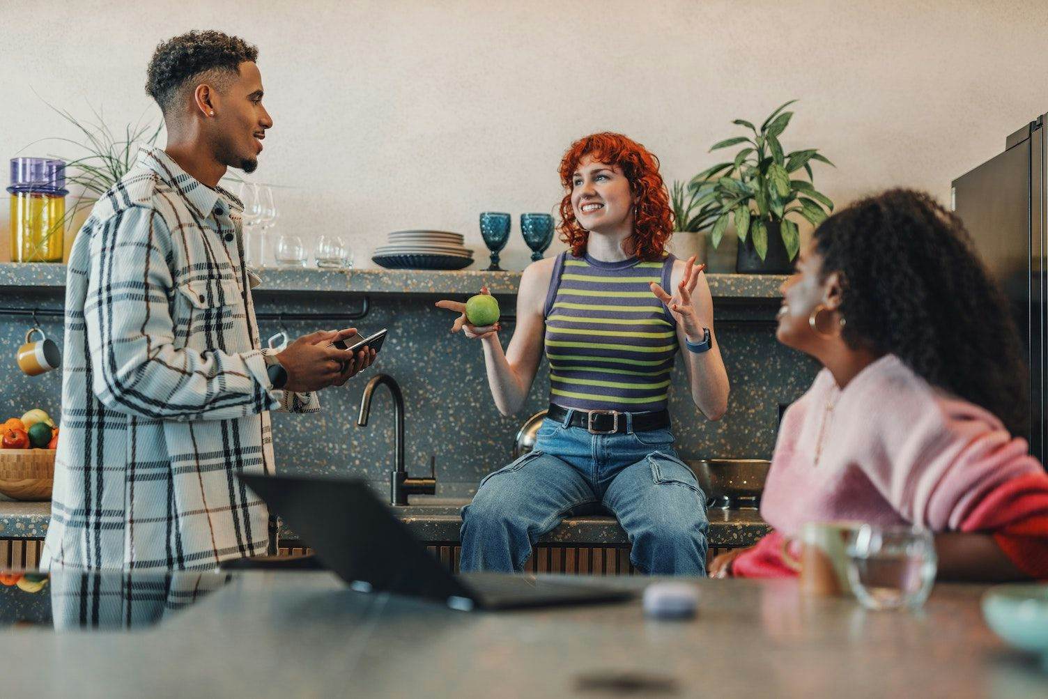 Team in the kitchen chatting at work