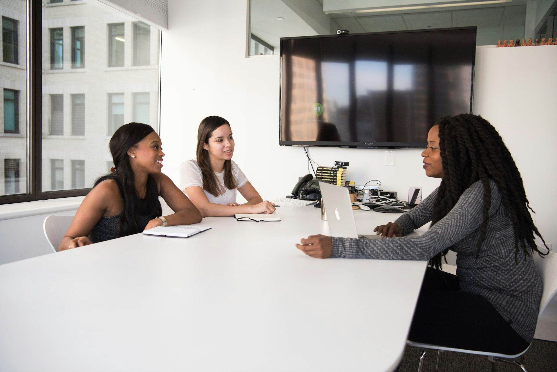 women talking in meeting room