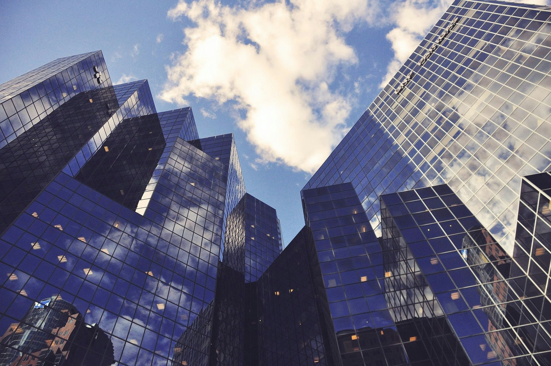 tall glass office buildings against blue sky