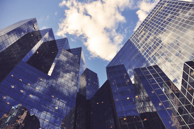 tall glass office buildings against blue sky