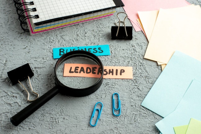 Magnifying glass on sticky note with leadership written on