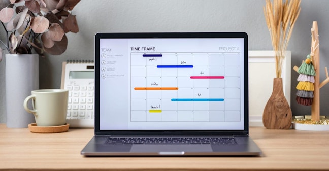 Laptop on desk with calendar task managing on screen