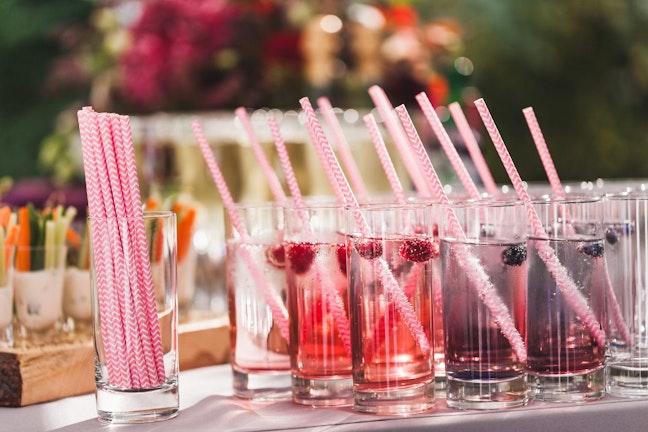 Cocktail style drinks with rasberries and red straws