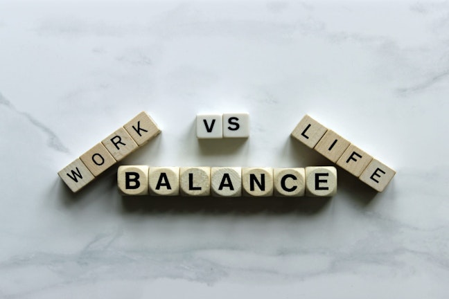 Lettered dice spelling out Work vs Life Balance