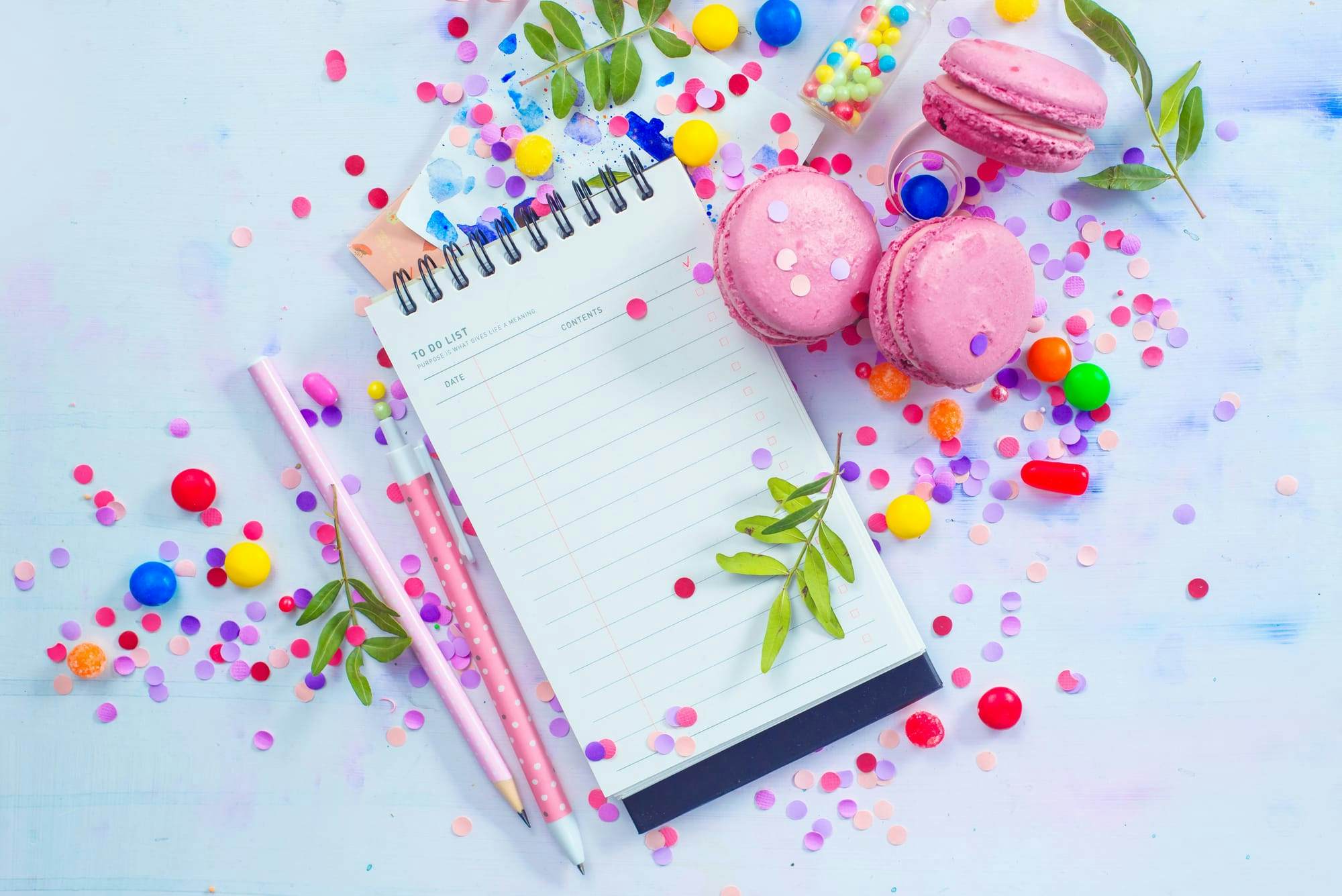 notepad with pink and rainbow confetti around