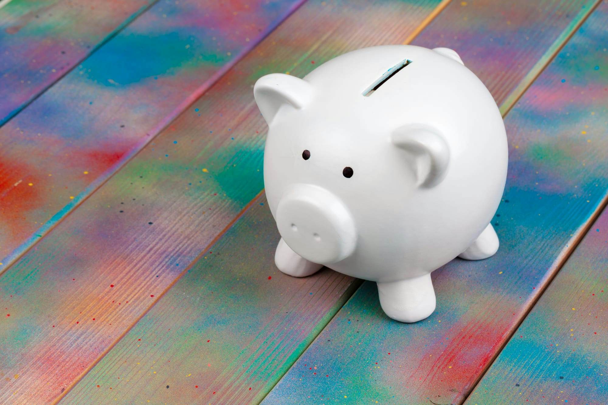 white piggy bank on a rainbow table